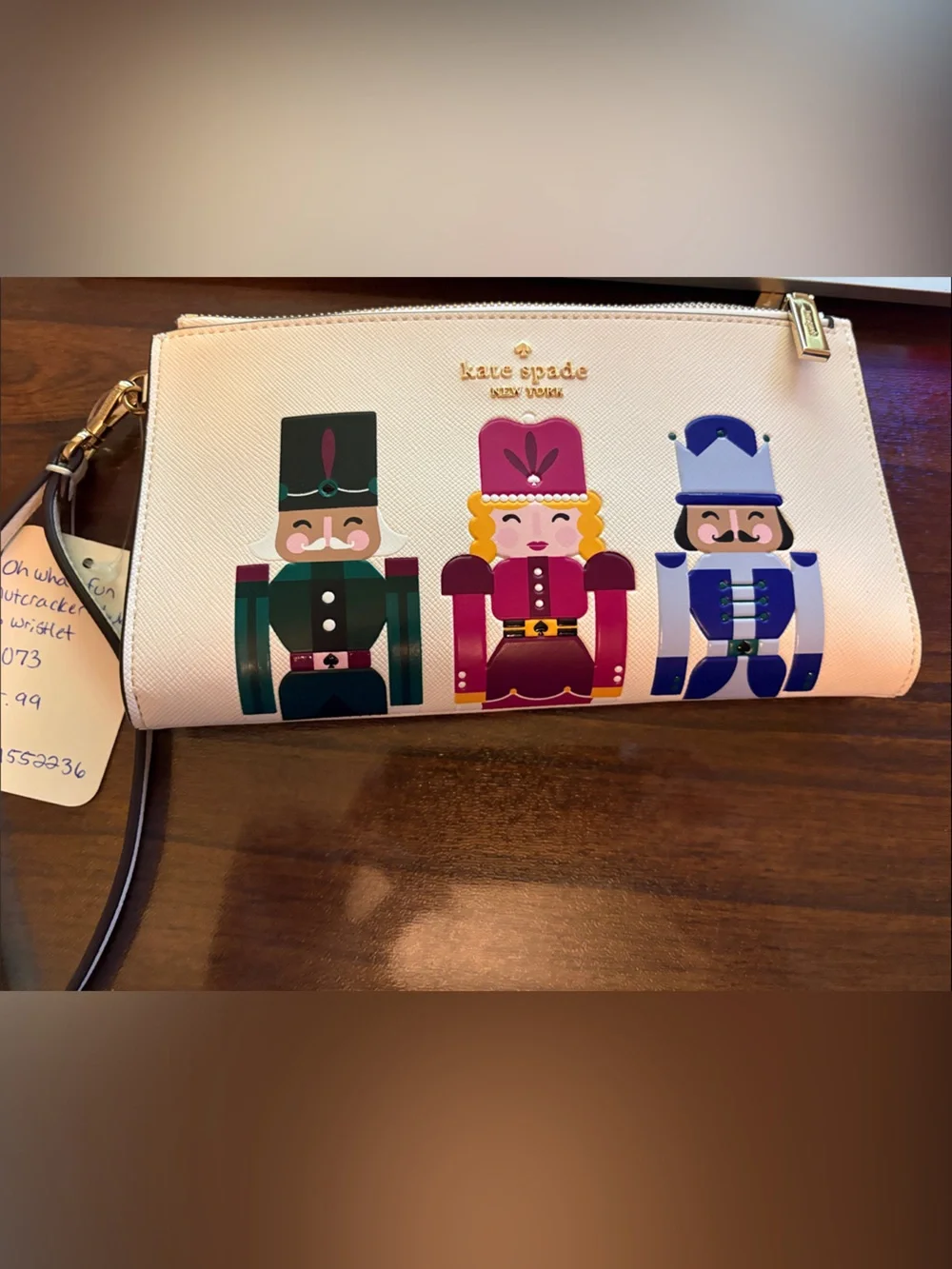 kate spade beige wristlet with colorful nutcracker trio